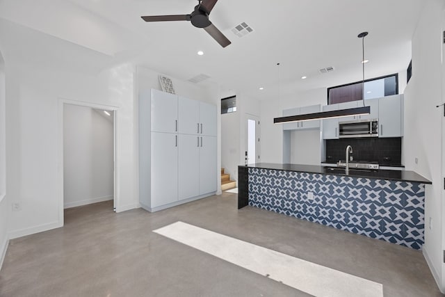 kitchen with decorative light fixtures, ceiling fan, decorative backsplash, and white cabinetry