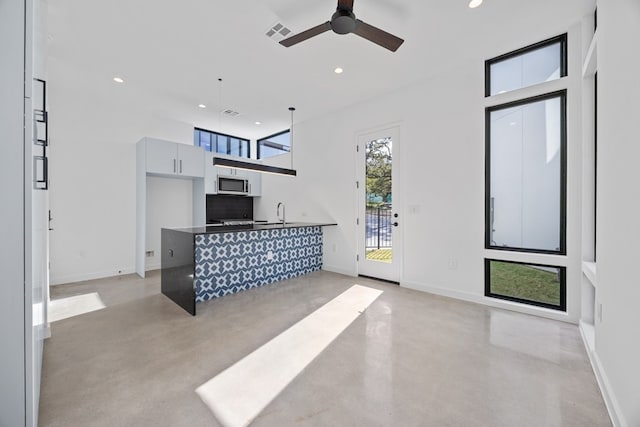 living room featuring sink and ceiling fan