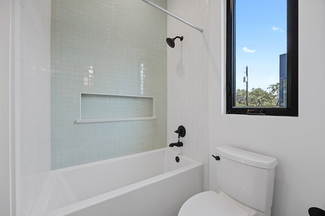 bathroom with toilet and tiled shower / bath combo