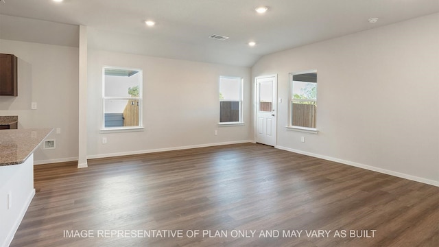 unfurnished living room with dark hardwood / wood-style floors and vaulted ceiling