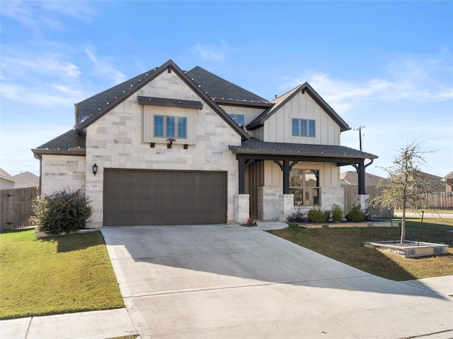 view of front of home with covered porch, a front lawn, and a garage