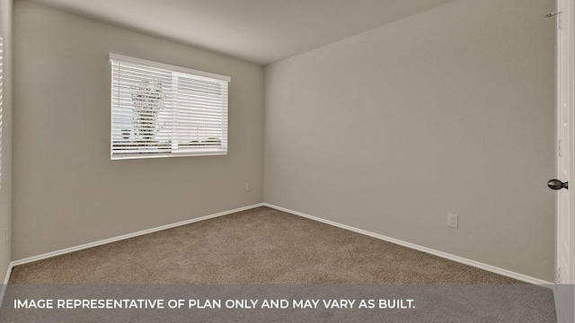 spare room featuring carpet floors and baseboards