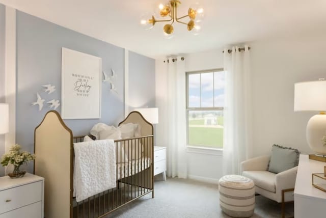 bedroom featuring light carpet, an inviting chandelier, and a nursery area