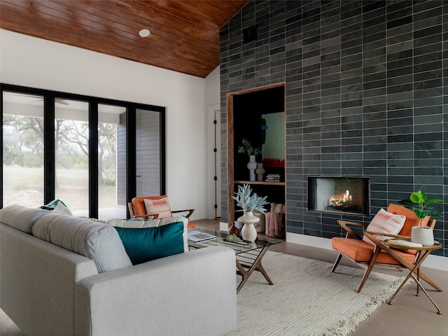 living room with wood ceiling, high vaulted ceiling, and a fireplace