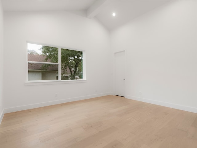 unfurnished room featuring high vaulted ceiling, light wood-type flooring, and beamed ceiling