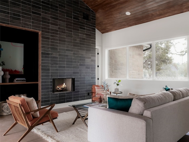 living room featuring wood ceiling, a tile fireplace, a wealth of natural light, and high vaulted ceiling