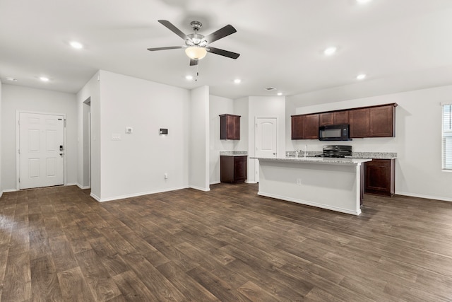 kitchen featuring dark hardwood / wood-style floors, ceiling fan, dark brown cabinets, and an island with sink