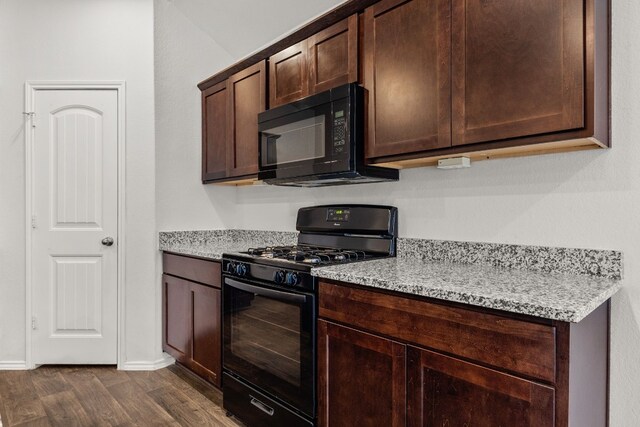 228 Rough Hollow Cv, San Marcos, TX 78666 - kitchen with black appliances, dark wood-type flooring, and dark brown cabinetry