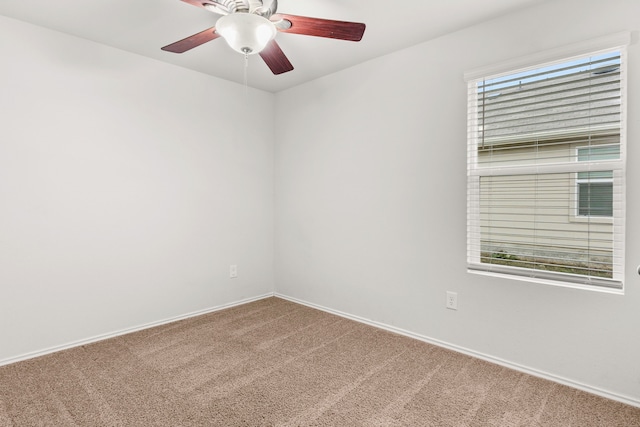 empty room with ceiling fan and carpet flooring