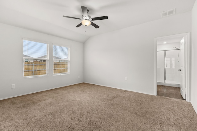 carpeted spare room with vaulted ceiling and ceiling fan