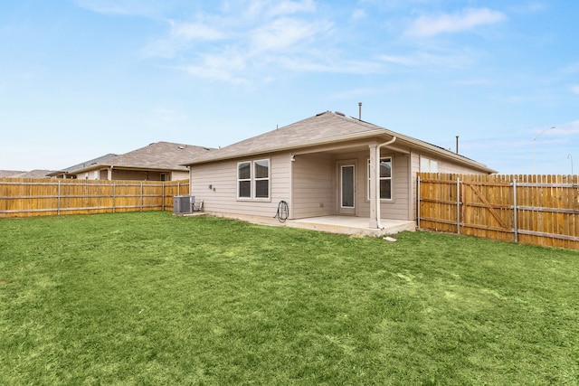 rear view of property with a patio area, central AC unit, and a lawn