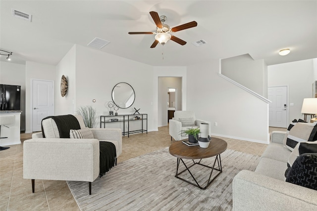 living room with ceiling fan and light tile patterned floors