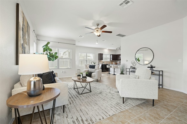 living room with ceiling fan and light tile patterned floors