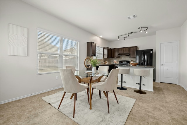 dining area featuring light tile patterned floors