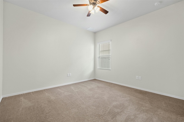 carpeted spare room with ceiling fan