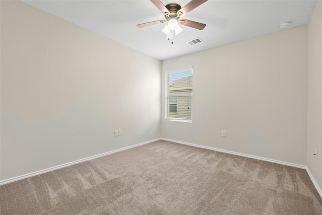 empty room featuring ceiling fan and carpet flooring