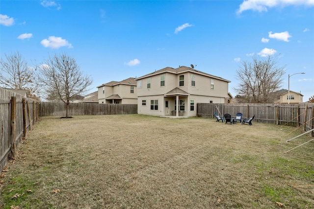 rear view of property featuring a yard