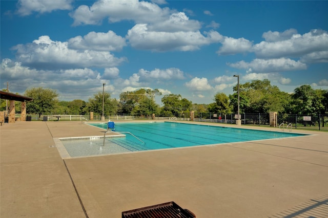 view of swimming pool featuring a patio area