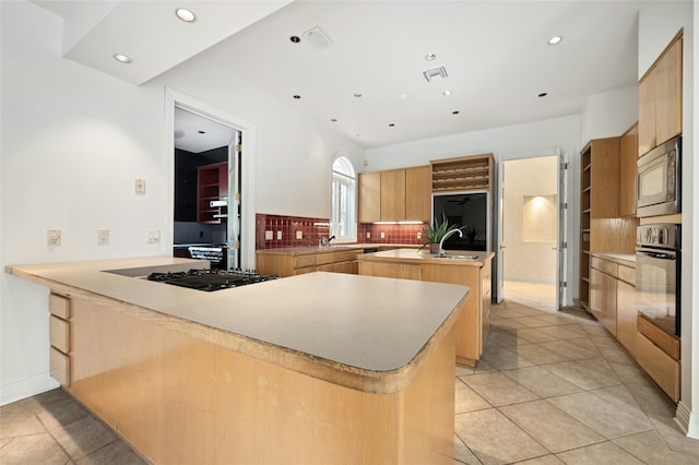 kitchen with black appliances, kitchen peninsula, light brown cabinetry, decorative backsplash, and light tile patterned flooring