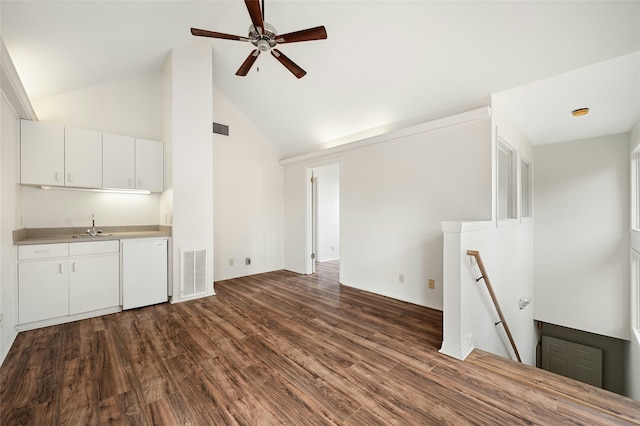 unfurnished living room with sink, high vaulted ceiling, dark hardwood / wood-style flooring, and ceiling fan