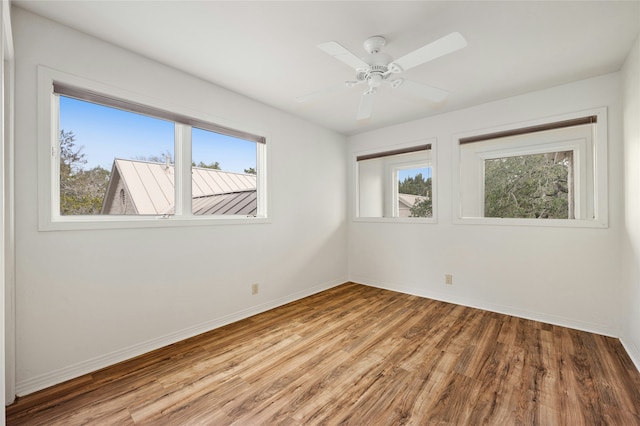 spare room featuring hardwood / wood-style floors and ceiling fan