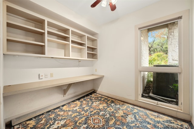 unfurnished office featuring ceiling fan