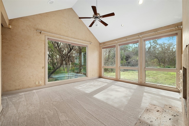 unfurnished sunroom with vaulted ceiling, ceiling fan, and a wealth of natural light