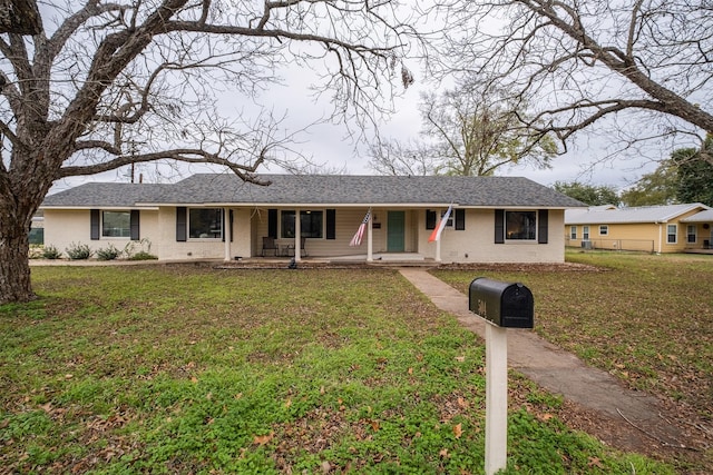 ranch-style home with a porch and a front lawn