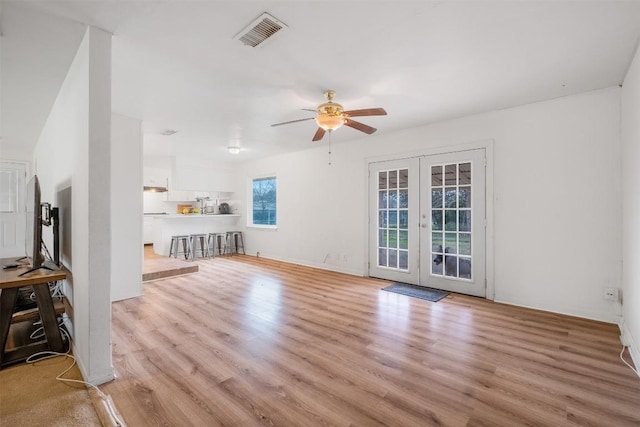 504 Marburger St, Smithville, TX 78957 - unfurnished living room featuring french doors, a ceiling fan, and light wood-type flooring