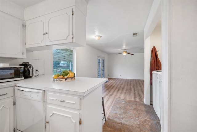 504 Marburger St, Smithville, TX 78957 - kitchen featuring white dishwasher, stainless steel microwave, ceiling fan, white cabinetry, and light countertops