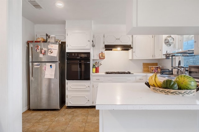 kitchen with white cabinetry, stainless steel appliances, sink, and light tile patterned floors