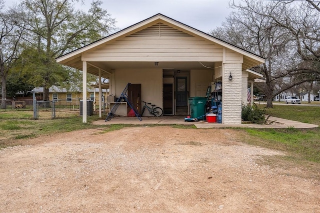 504 Marburger St, Smithville, TX 78957 - view of outdoor structure with dirt driveway, central AC, and a carport