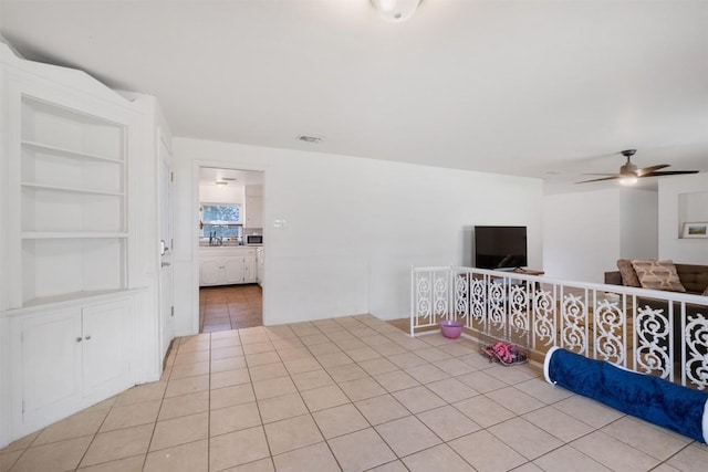 504 Marburger St, Smithville, TX 78957 - empty room featuring light tile patterned flooring and ceiling fan