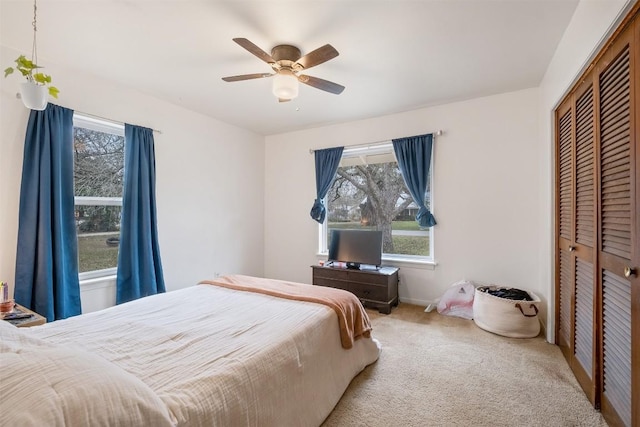 504 Marburger St, Smithville, TX 78957 - carpeted bedroom with a closet, multiple windows, and a ceiling fan