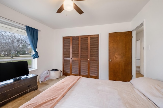 bedroom featuring light colored carpet and ceiling fan