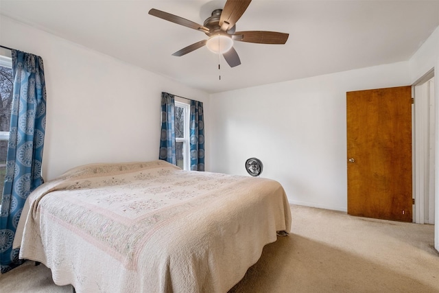 carpeted bedroom featuring ceiling fan