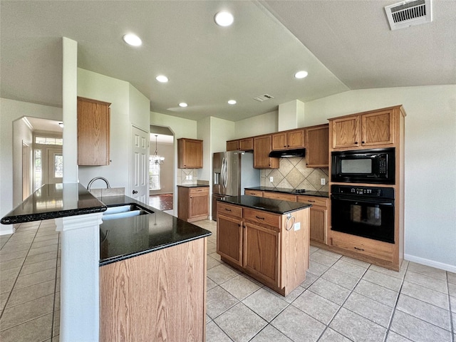 kitchen featuring vaulted ceiling, light tile patterned floors, kitchen peninsula, decorative backsplash, and black appliances