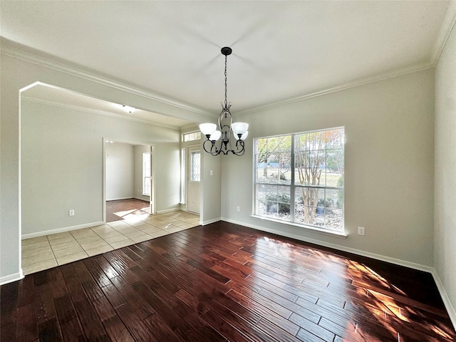 unfurnished dining area featuring light hardwood / wood-style flooring, an inviting chandelier, and crown molding