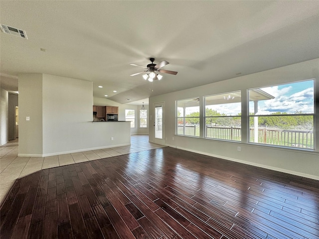 unfurnished living room with ceiling fan and lofted ceiling