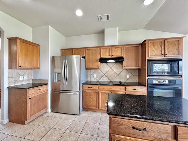 kitchen with black appliances, dark stone countertops, decorative backsplash, and light tile patterned floors