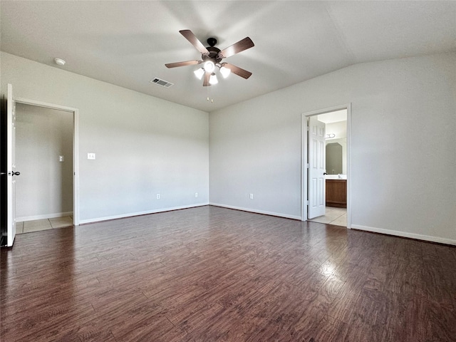 empty room with vaulted ceiling, hardwood / wood-style flooring, and ceiling fan