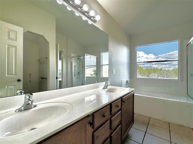 bathroom with vanity, tile patterned flooring, and plus walk in shower