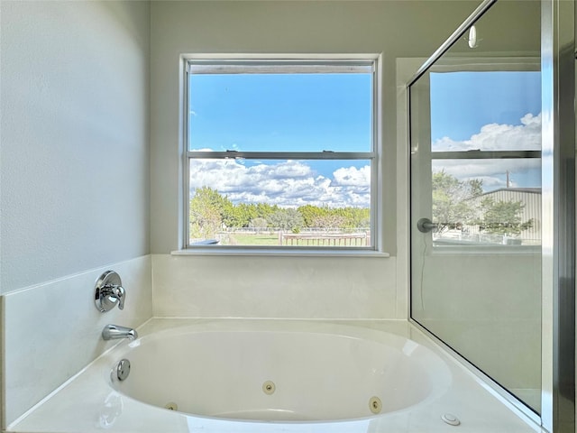 bathroom with a tub to relax in