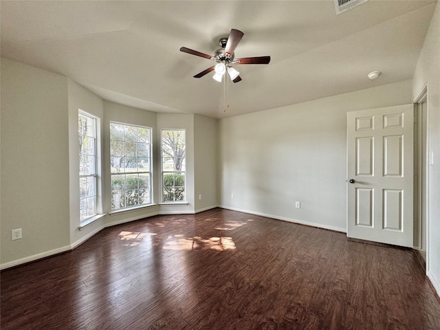 unfurnished room featuring ceiling fan and dark wood-type flooring