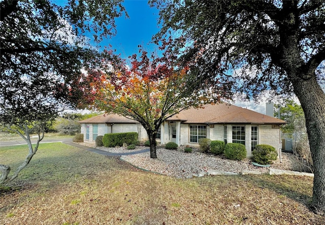 ranch-style house with a front lawn