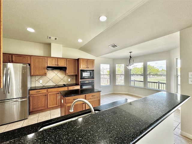 kitchen with vaulted ceiling, hanging light fixtures, black appliances, tasteful backsplash, and sink