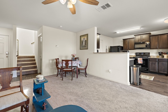 living room featuring ceiling fan and carpet