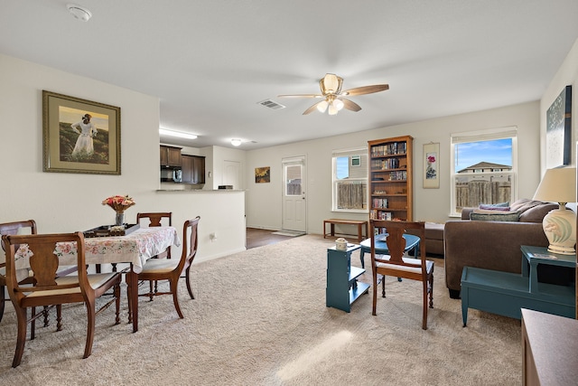 interior space featuring light carpet and ceiling fan