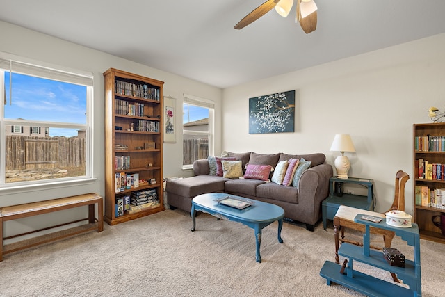 living room with light carpet and ceiling fan