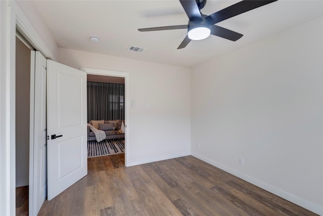 unfurnished bedroom featuring a closet, ceiling fan, and wood-type flooring